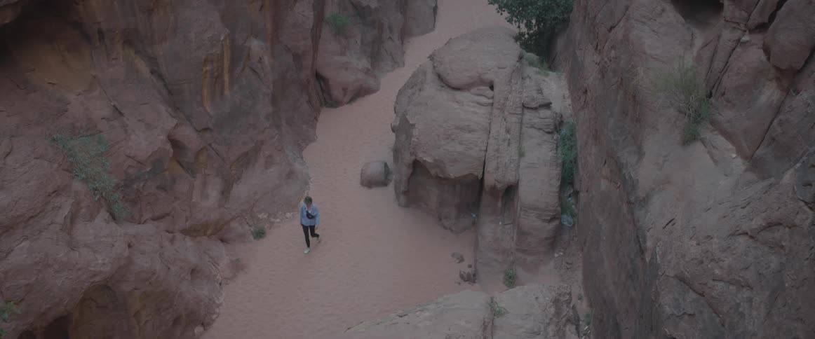Panorama of a person walking amid the valleys