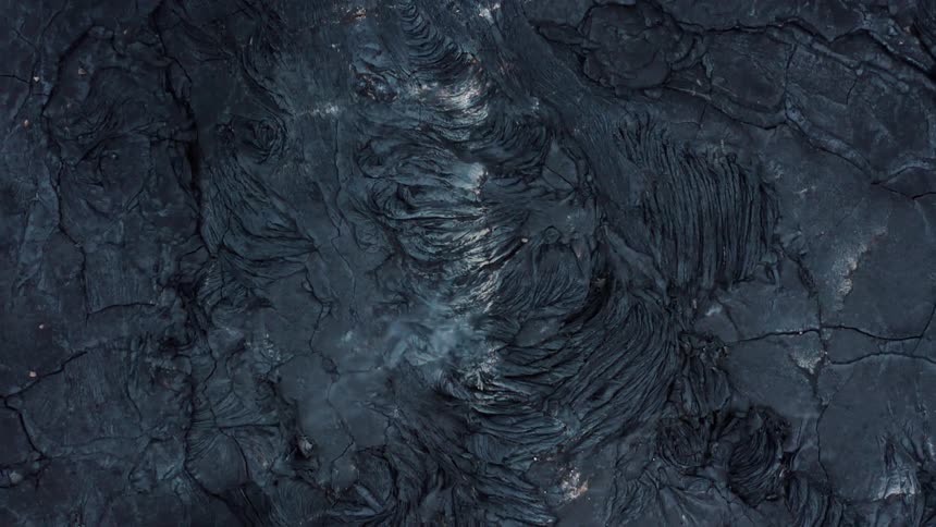 Aerial of rock formations of an erupting volcano