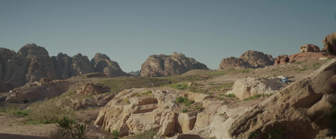 Panorama of mountains and a valley on a day with a cloudless blue sky