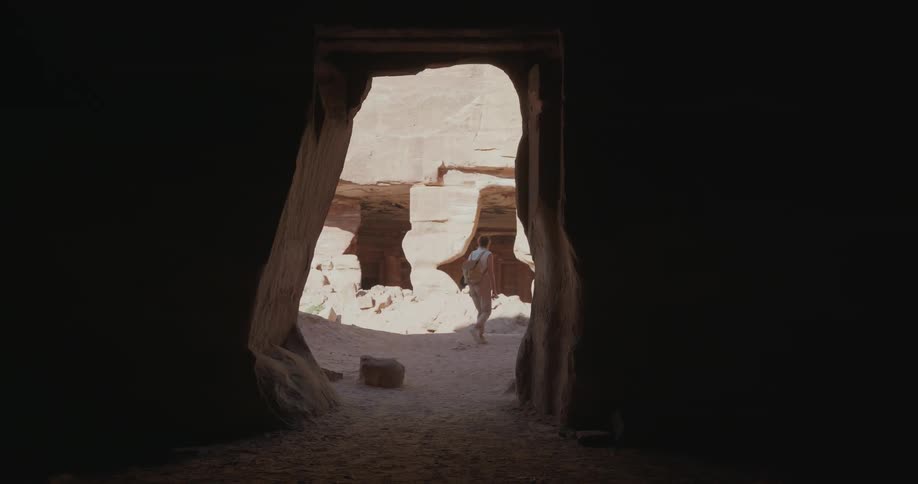 Woman walking amidst geological valleys
