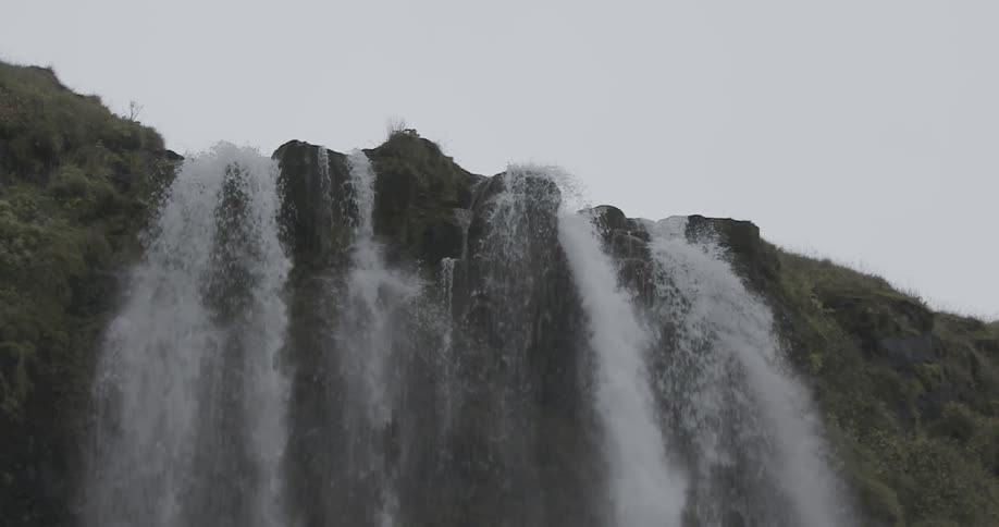 Water falls in multiple streams over a cliff edge
