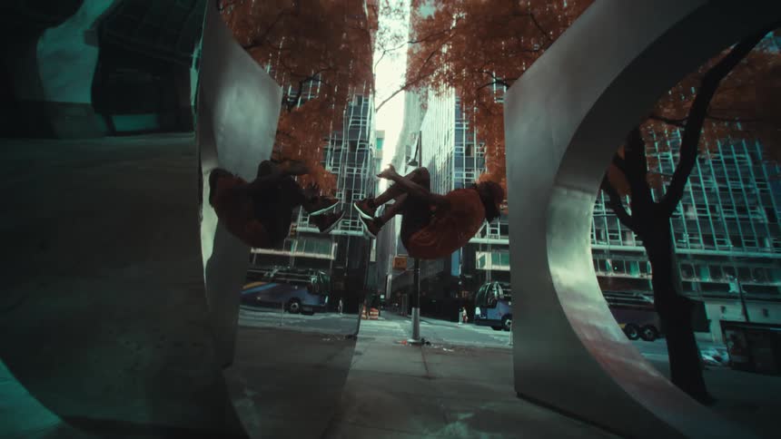 A man doing somersaults on a monument in the urban city