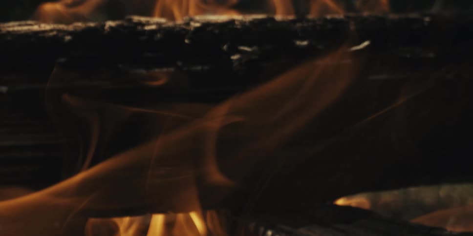 A stack of logs are on fire