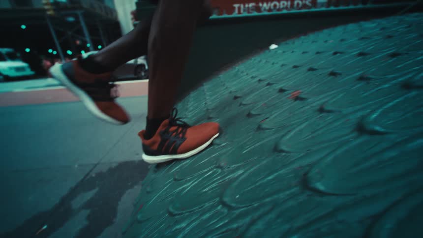 A person running on a metal structure in the city