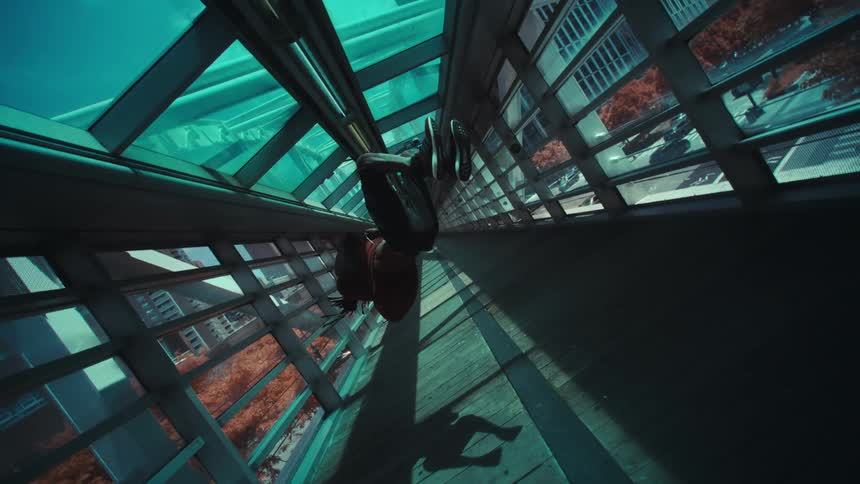 A young man doing somersaults in a hallway