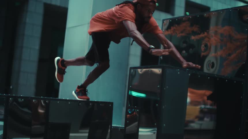 Man jumping in parkour under public objects