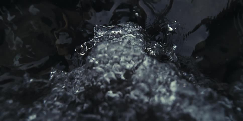 Clear stream receives falling water creating a gentle refreshing flow