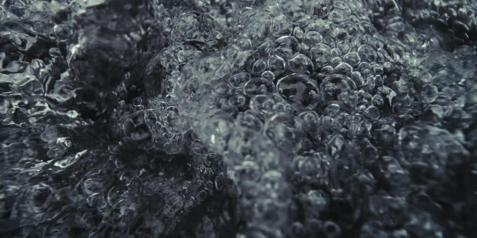 Waves of liquid bubbles crashing against each other