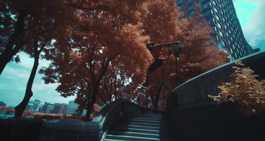 A boy practicing parkour on a city staircase