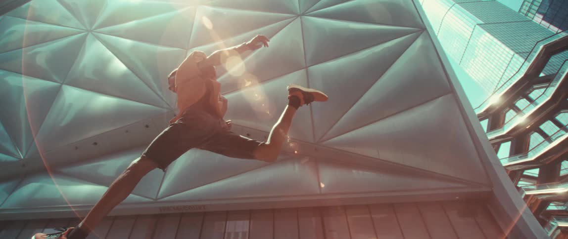 A man jumping between spaces in a building