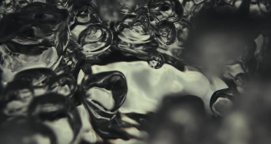 Extreme closeup on moving water with bubbles