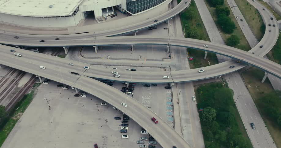 Aerial view of vehicles driving on an urban freeway interchange