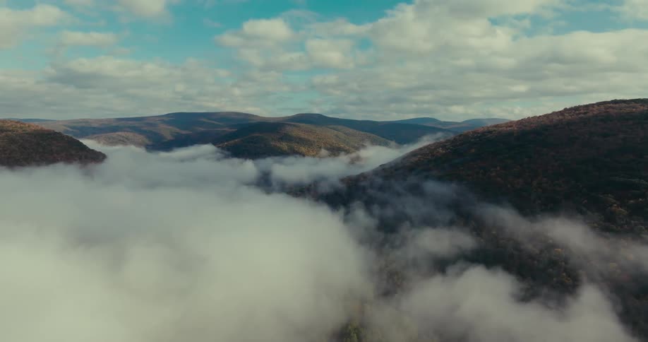A region with mountains and a large fog covering the ground