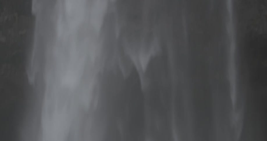 A waterfall cascades over a cliff