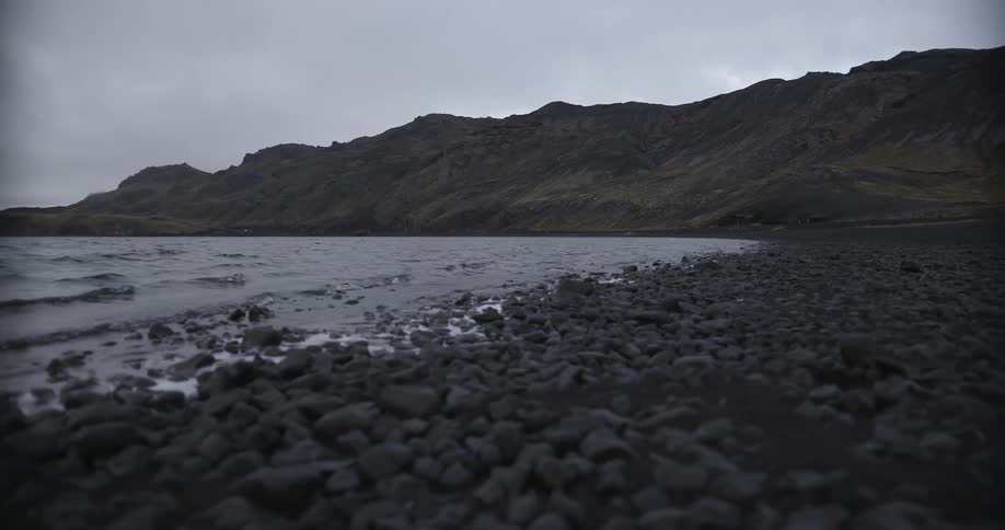 Waves come ashore on a rocky shoreline