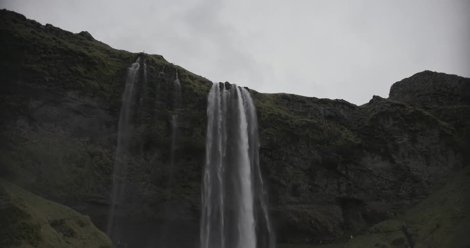 Water streams down the cliff on a cloudy day