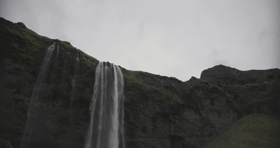 A waterfall splashing off of a cliff