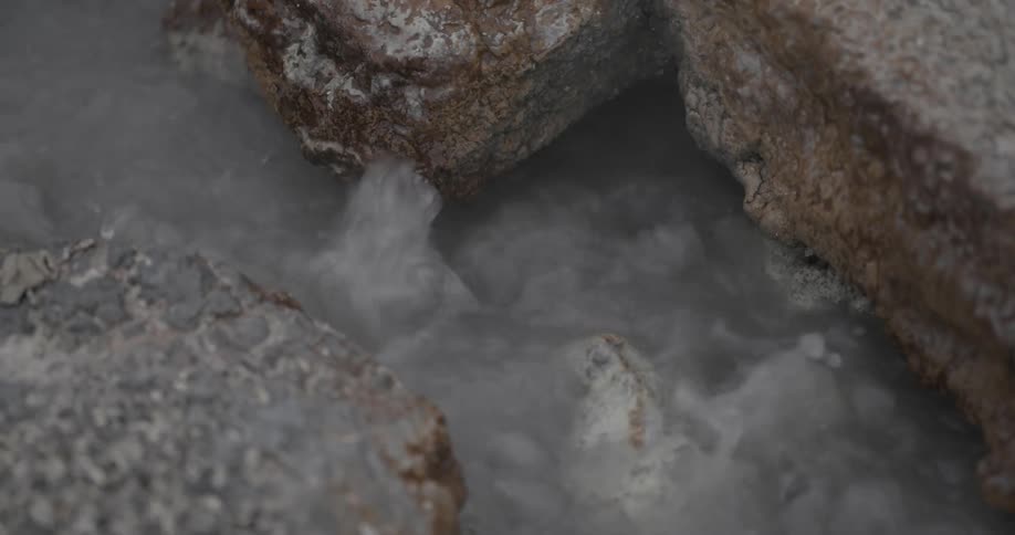 Water bubbles and flows between rocks