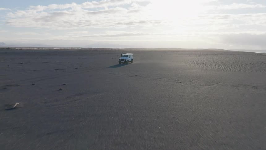 An atv driving across a rocky desert