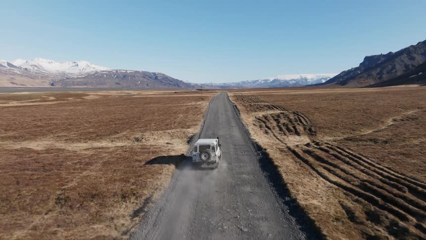 A truck drives down the dirt road