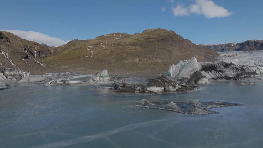 Icebergs float in the water by the shore