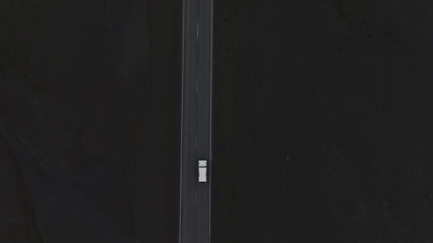 A truck drives down the long highway
