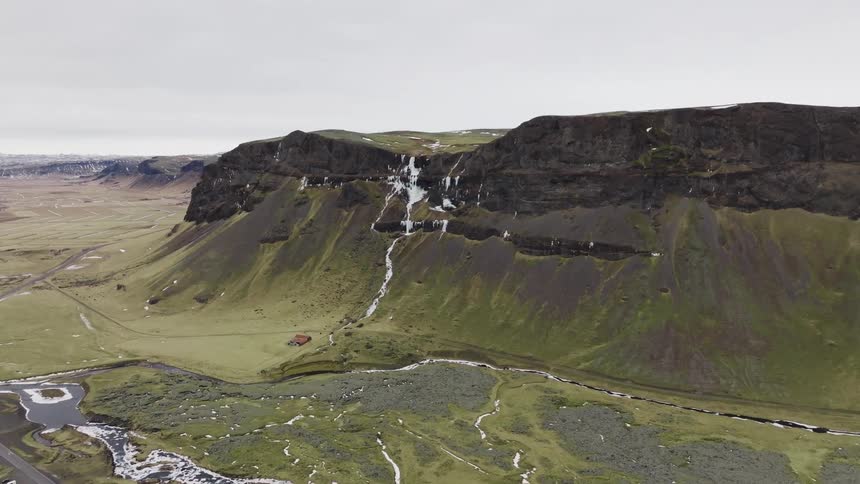 Panorama of a mountain with remnants of snow on a cloudy day