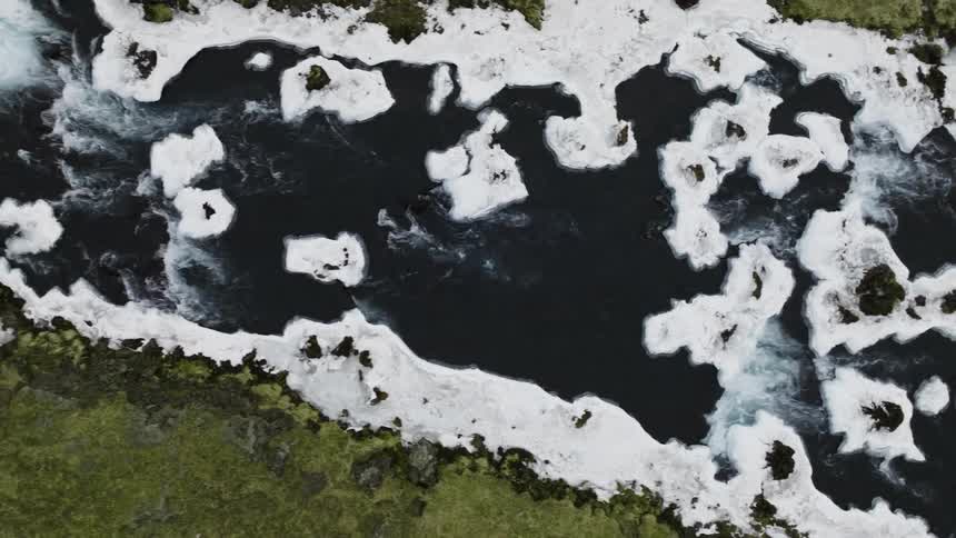 A river with strong currents and foam in the water