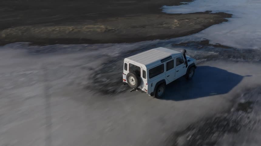 Jeep driving on frozen ground