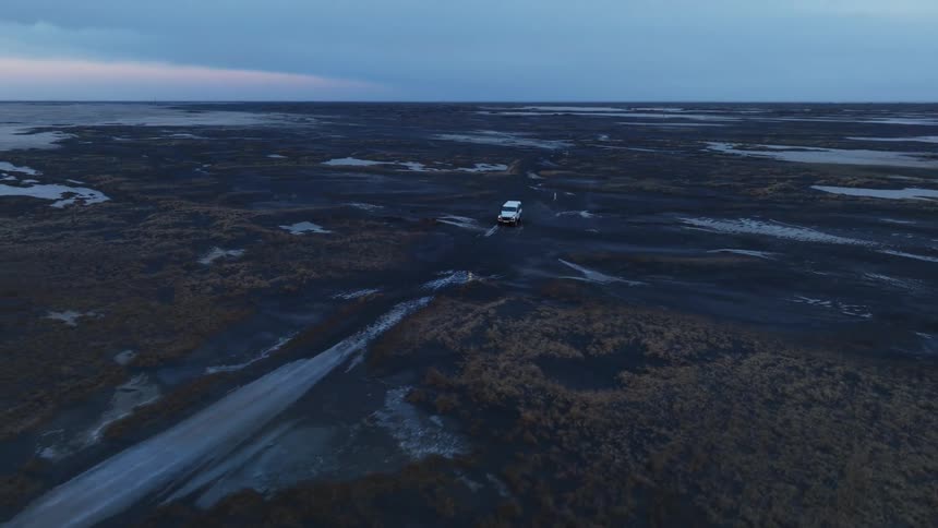 Panorama of a car driving through a natural black soil environment