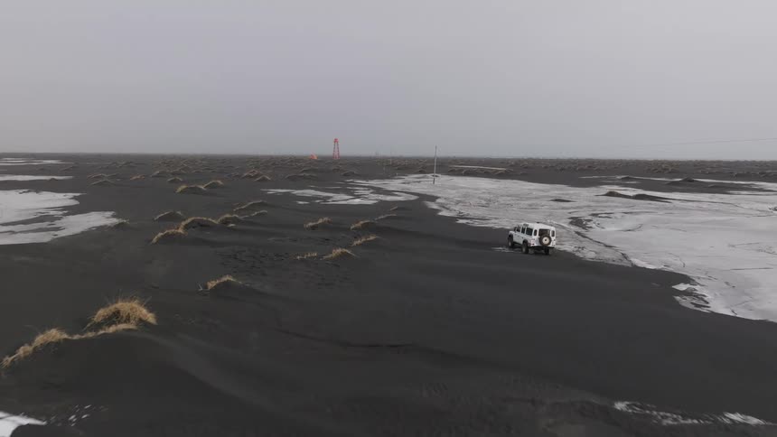 A vehicle is driving off road through the ice