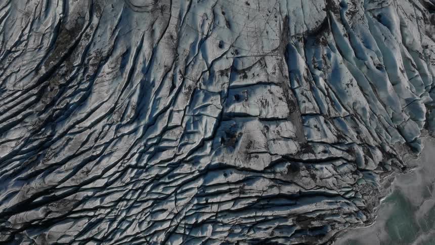 An aerial view captures a rocky mountain slope showcasing the rugged terrain from above