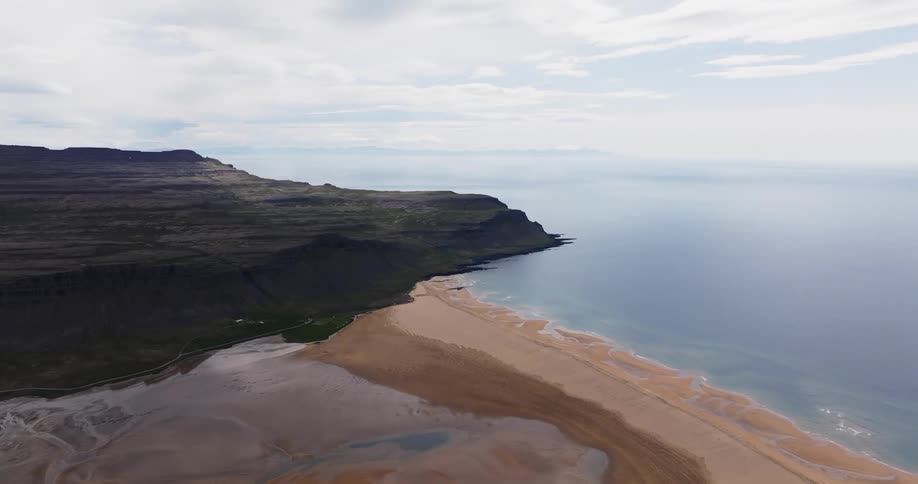 Aerial panorama of a beach with the sea coast on a blue sky day with clouds