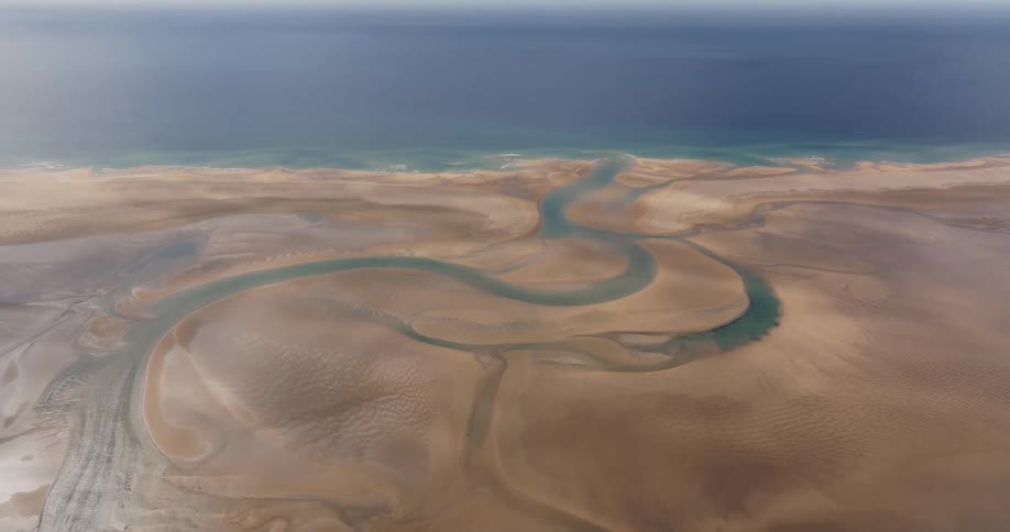 Aerial view of sand amidst turquoise blue sea