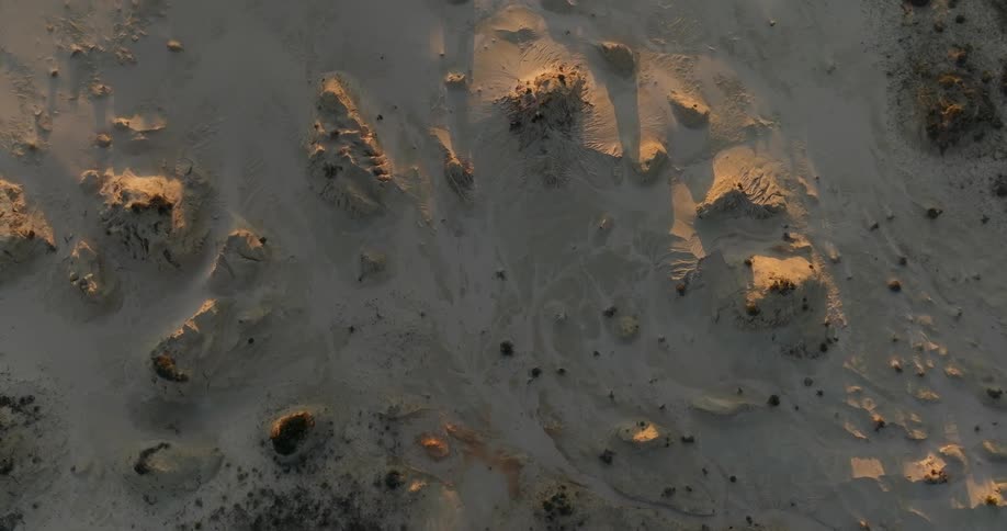 Aerial of a desert with rock formations during sunset