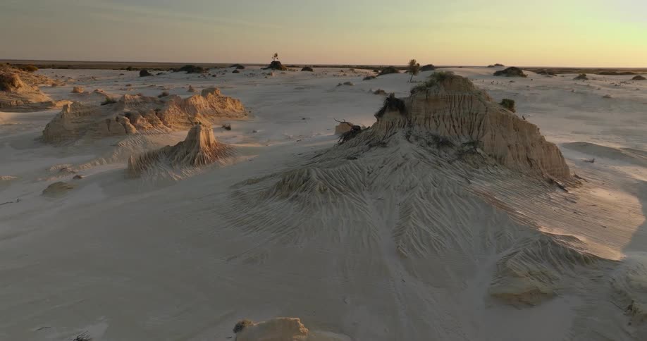 Aerial of sand mountains in the desert during sunset