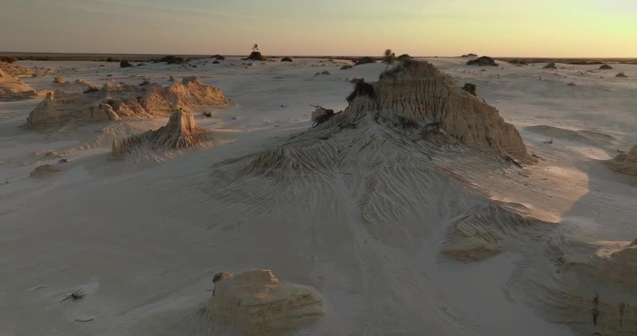 Aerial of a mountain range in the desert during sunset