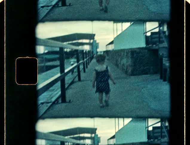 Girl walking on a pier caught on vintage film