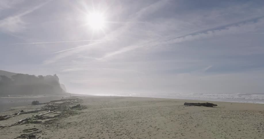 Panorama of a beach with calm water along the coastline and the sea on the other side