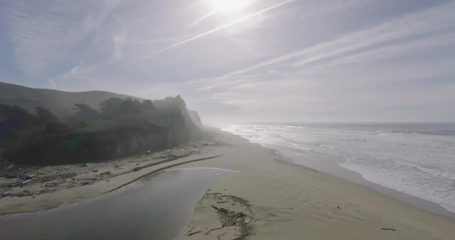 Aerial of the deserted beach with birds at the seaside