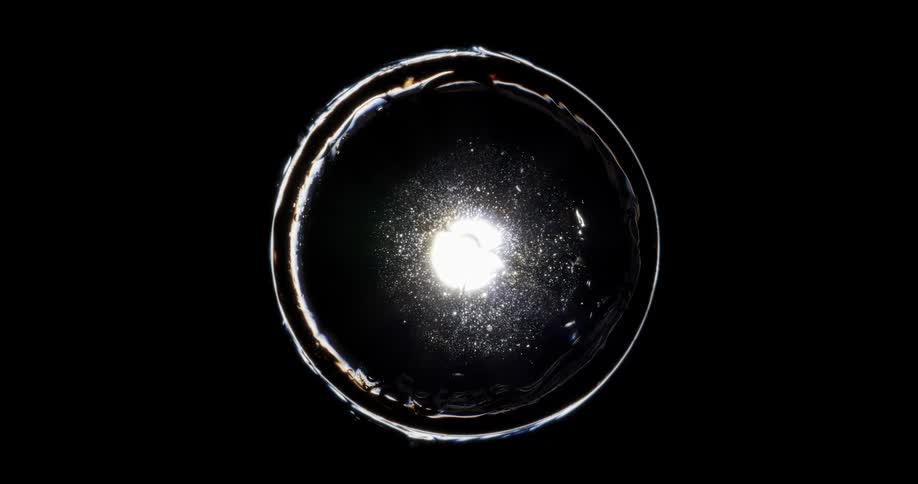 Extreme closeup of a shiny and abstract liquid bubble on a black background