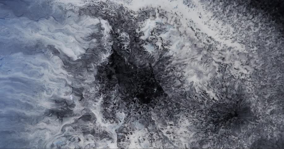 White streaks flow outward revealing darker center of churning mixture