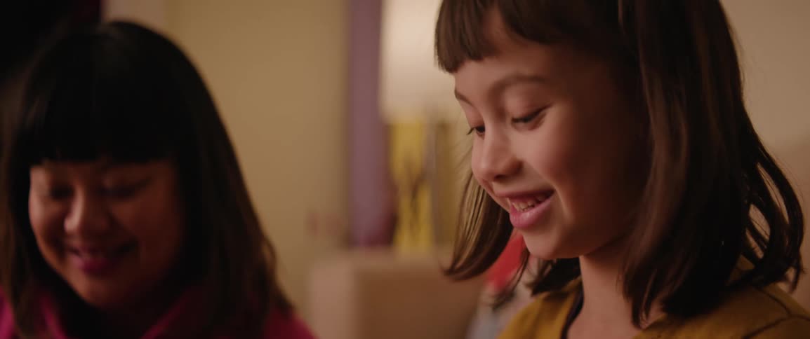 Closeup of the faces of a girl and a smiling mother