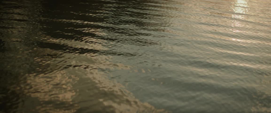Late afternoon sunlight shines on the water as it ripples and waves