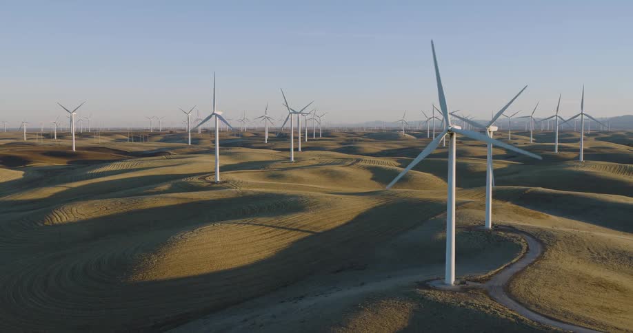Panorama of a field with wind turbine engines and platforms