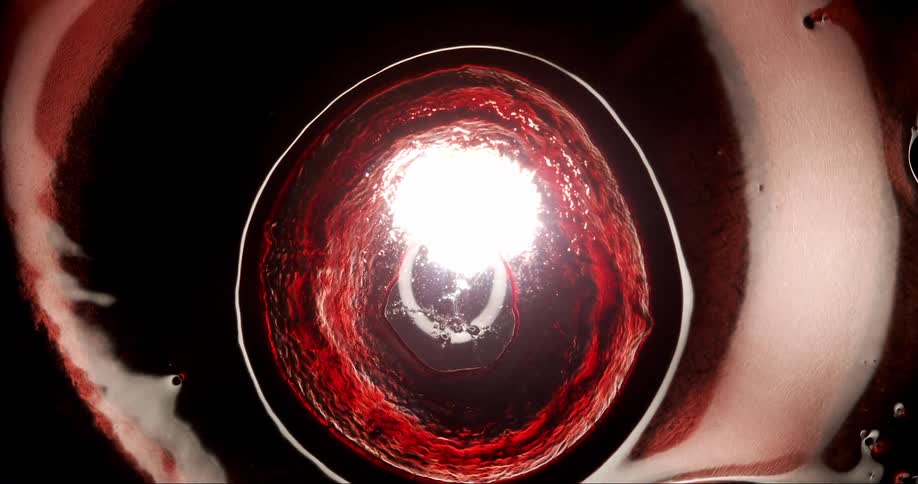 Extreme closeup of abstract red liquid in slow motion