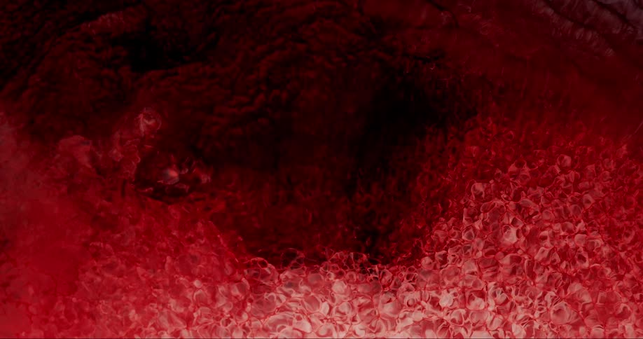 Microscopic view of red fluid in slow motion