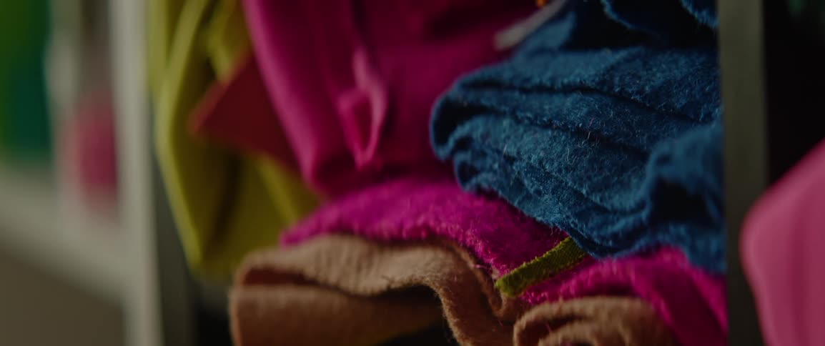 Wooden cubby hole holds multiple folded layers of cloth