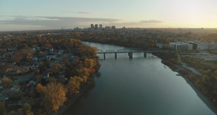 Downtown Winnipeg is seen at sunset behind winding Red River