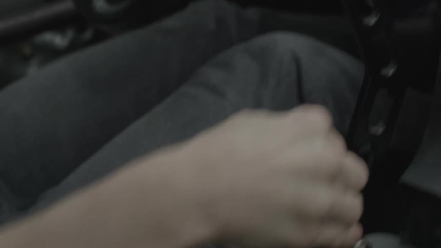 Close up of a hand shifting gear on a race car